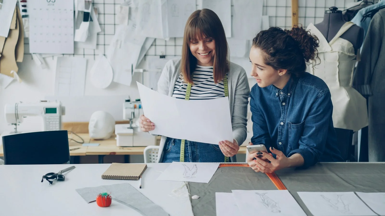Two fashion designers review a clothing pattern - Photo by Vitaly Gariev on Unsplash Two fashion designers review a clothing pattern