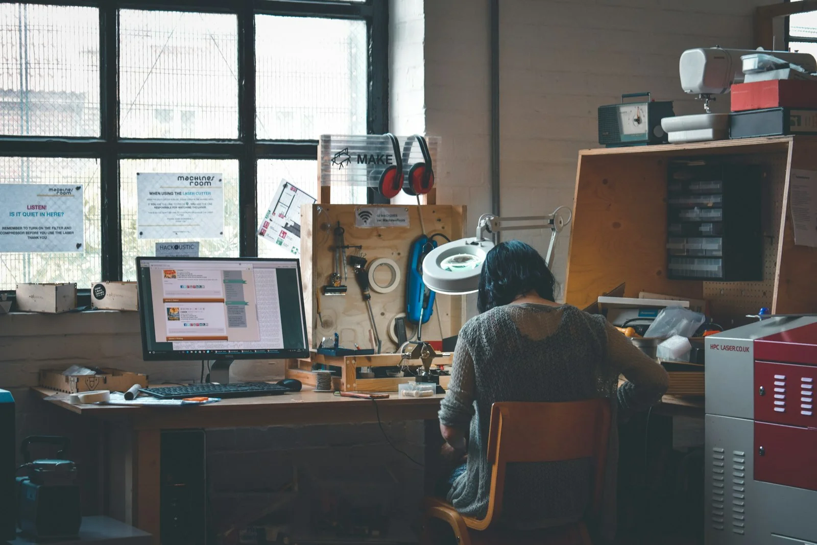 woman sitting in front of a wooden desk woman sitting in front of a wooden desk